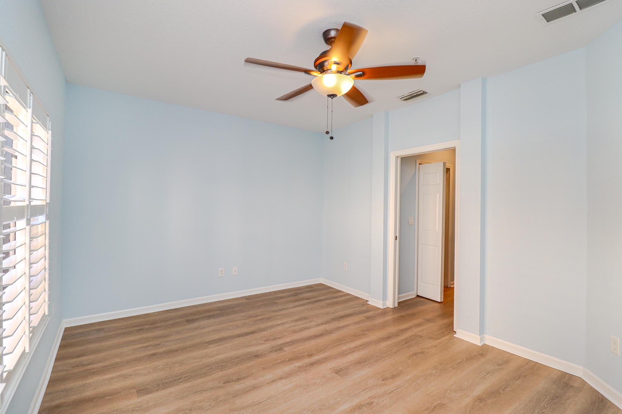 305 Via Castilla, Unit 103 St. Augustine, FL 32095 - Photo 13 of 34 wooden floor in an empty room with a window