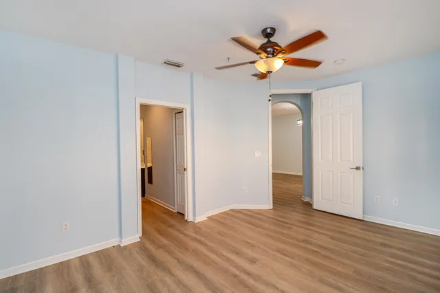 a view of a livingroom with a ceiling fan and wooden floor