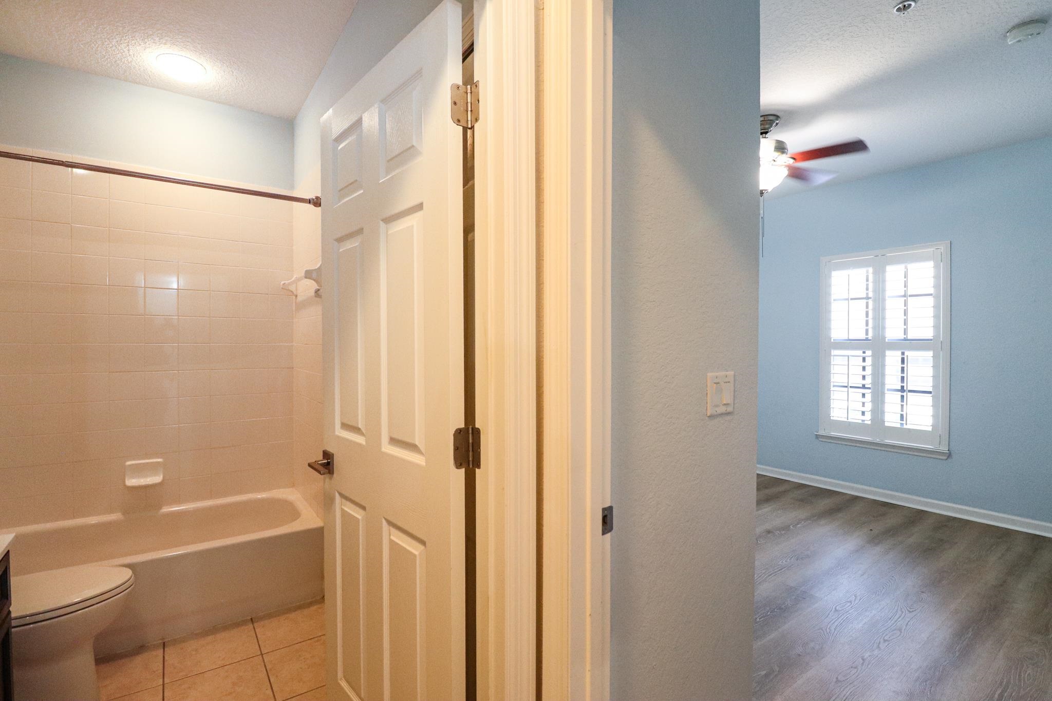 305 Via Castilla, Unit 103 St. Augustine, FL 32095 - Photo 23 of 34 a bathroom with a bathtub a toilet and a shower
