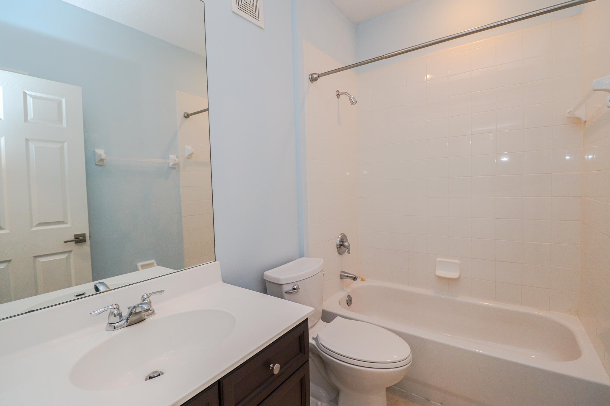 305 Via Castilla, Unit 103 St. Augustine, FL 32095 - Photo 24 of 34 a bathroom with a sink a toilet and shower