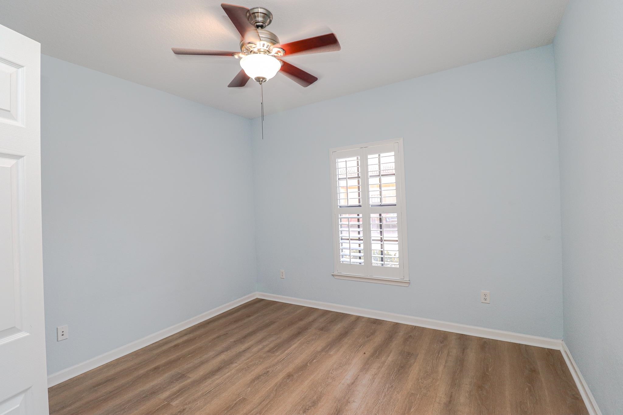 305 Via Castilla, Unit 103 St. Augustine, FL 32095 - Photo 25 of 34 an empty room with a window and a fan