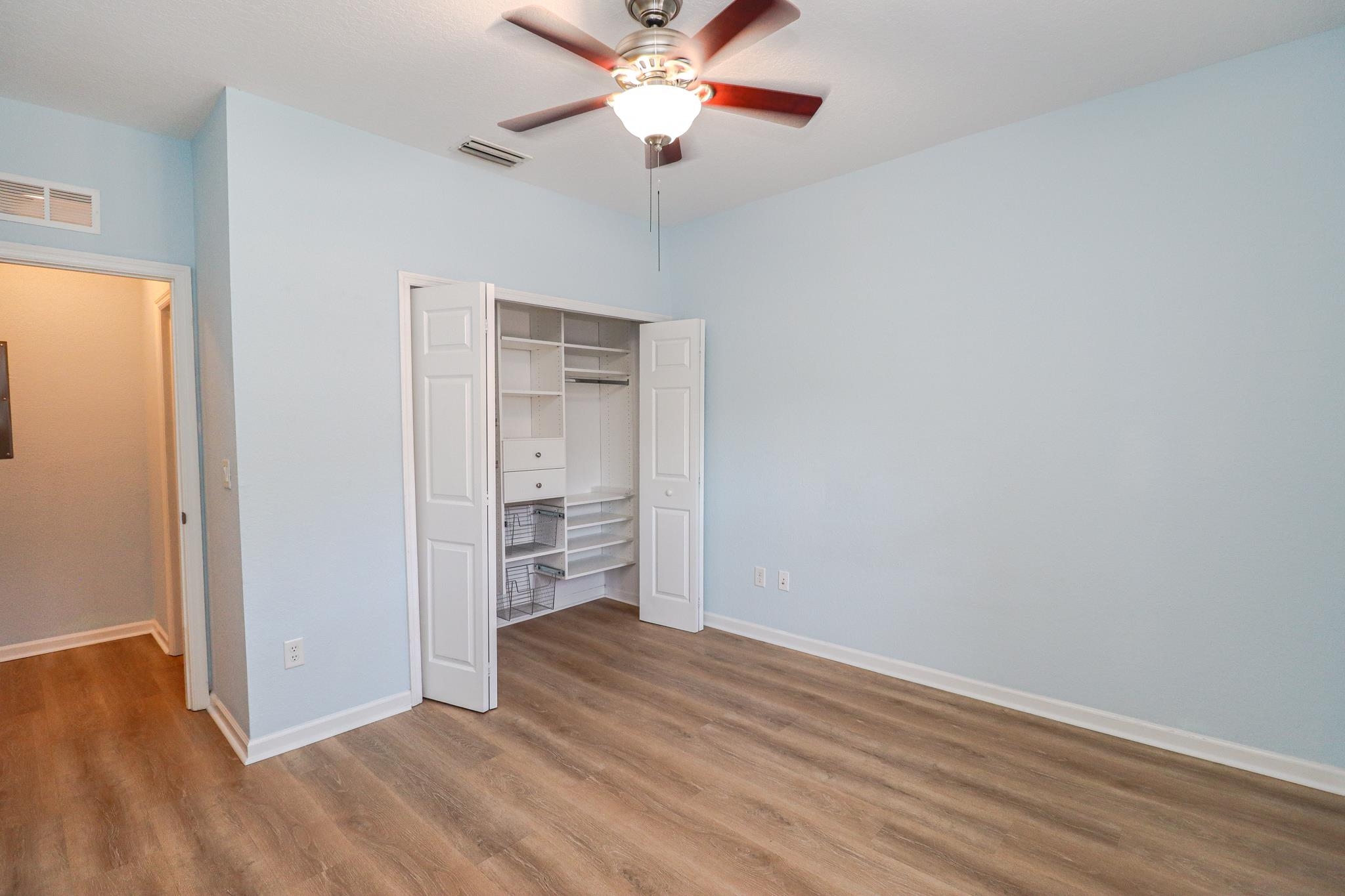 305 Via Castilla, Unit 103 St. Augustine, FL 32095 - Photo 26 of 34 wooden floor in an empty room with a window