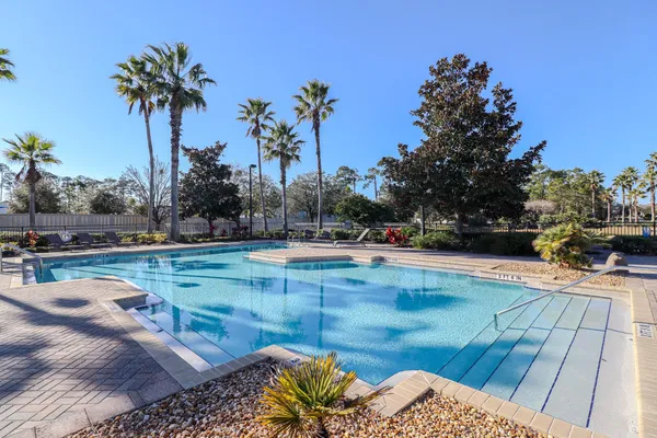 a view of swimming pool with a patio and a garden