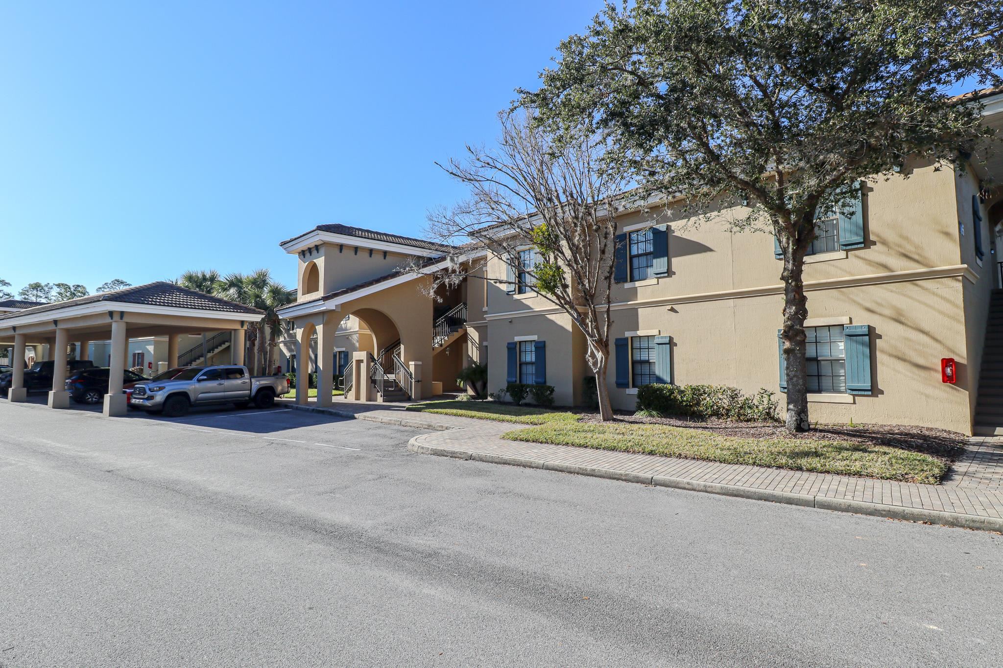 305 Via Castilla, Unit 103 St. Augustine, FL 32095 - Photo 33 of 34 a front view of a house with a yard