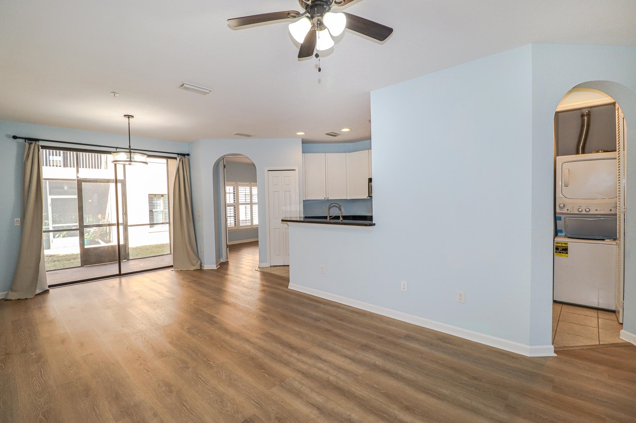 305 Via Castilla, Unit 103 St. Augustine, FL 32095 - Photo 4 of 34 a view of an empty room with window and wooden floor