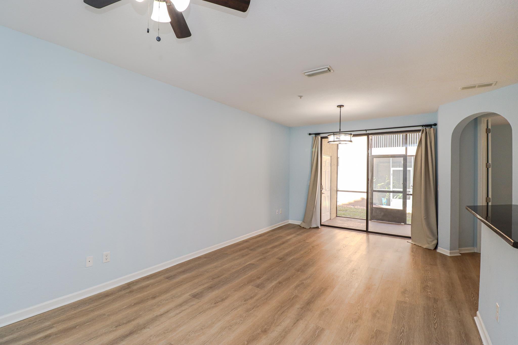 305 Via Castilla, Unit 103 St. Augustine, FL 32095 - Photo 5 of 34 wooden floor in an empty room with a window