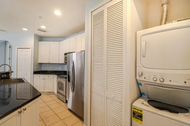 a kitchen with a stove a sink and a refrigerator