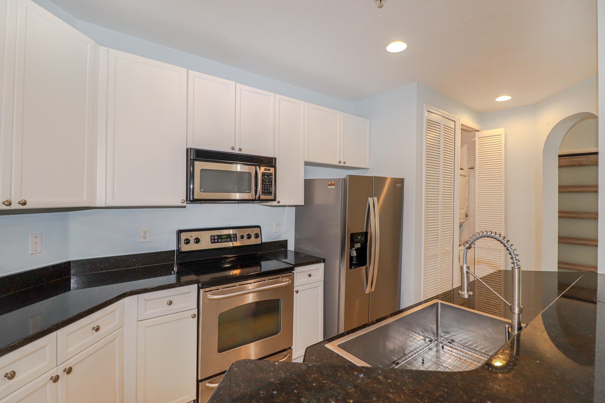305 Via Castilla, Unit 103 St. Augustine, FL 32095 - Photo 10 of 34 a kitchen with stainless steel appliances granite countertop a refrigerator a stove and a sink