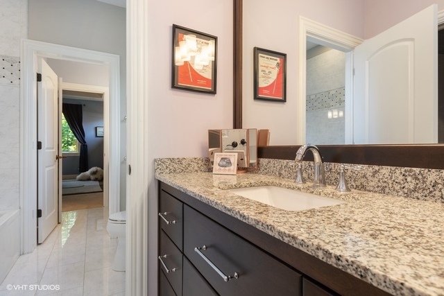 122 Walnut Street Elmhurst, IL 60126 - Photo 24 of 41 a en suite bathroom with a granite countertop sink and a mirror