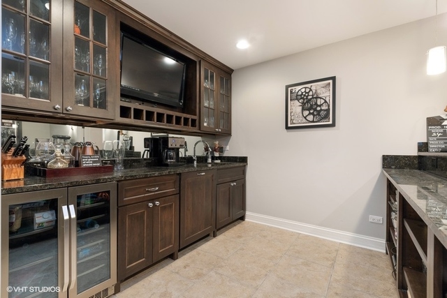 122 Walnut Street Elmhurst, IL 60126 - Photo 34 of 41 a kitchen with granite countertop a stove and a flat screen tv
