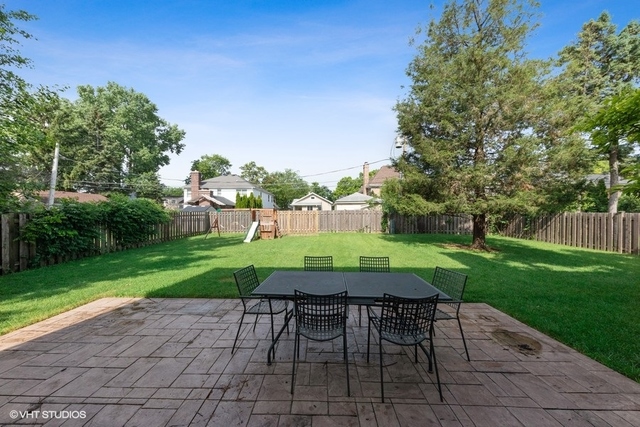 122 Walnut Street Elmhurst, IL 60126 - Photo 41 of 41 a view of a table and chairs in backyard of the house