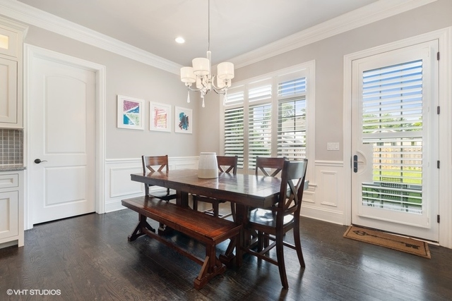 122 Walnut Street Elmhurst, IL 60126 - Photo 10 of 41 a dining room with wooden floor a chandelier a wooden table and chairs