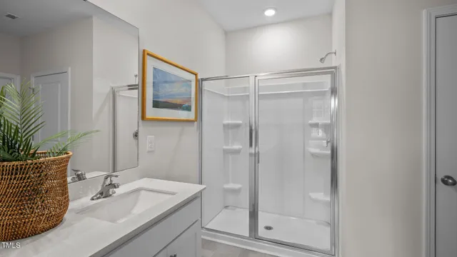 a bathroom with a tub shower vanity and a sink