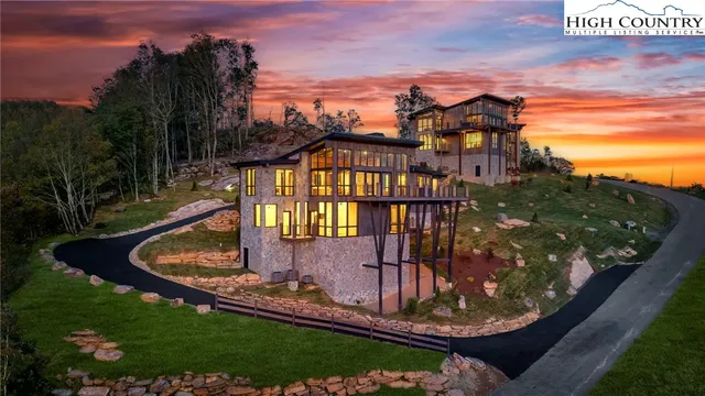 a living room with furniture large window and a fireplace
