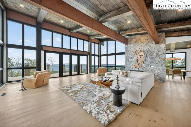 a bedroom with furniture and a large window