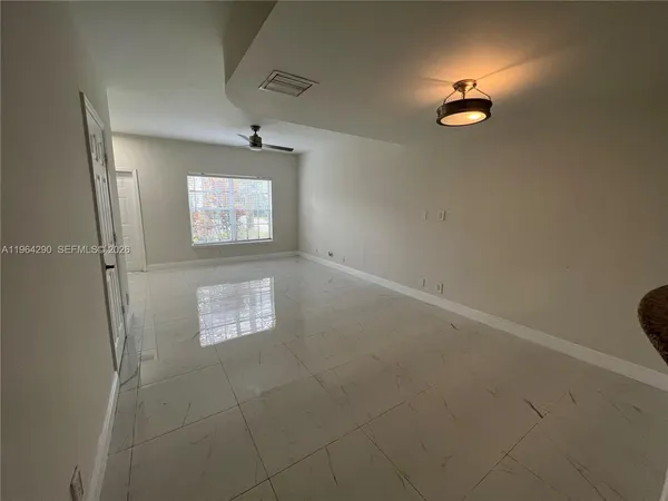 a view of an empty room with a window