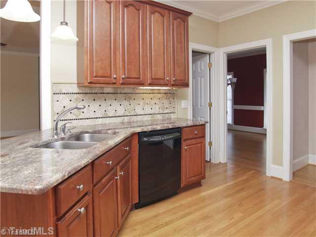5411 Effieham Street Oak Ridge, NC 27310 - Photo 3 of 16 Kitchen. The kicthen includes all the appliances and has been updated with custom granite countertops and tile backsplash. The microwave is less than 2 years old.