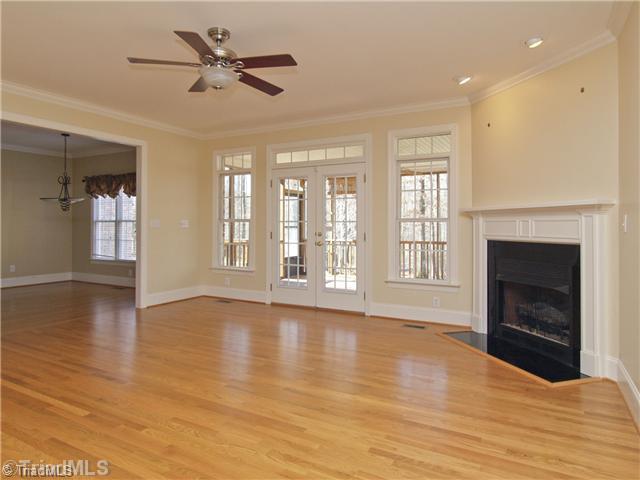 5411 Effieham Street Oak Ridge, NC 27310 - Photo 7 of 16 Den/Family/Great Room. The great room is at the rear of the home and has a gas log fireplace and wonderful wood floors. Fabulous open plan that is an entertainers dream.