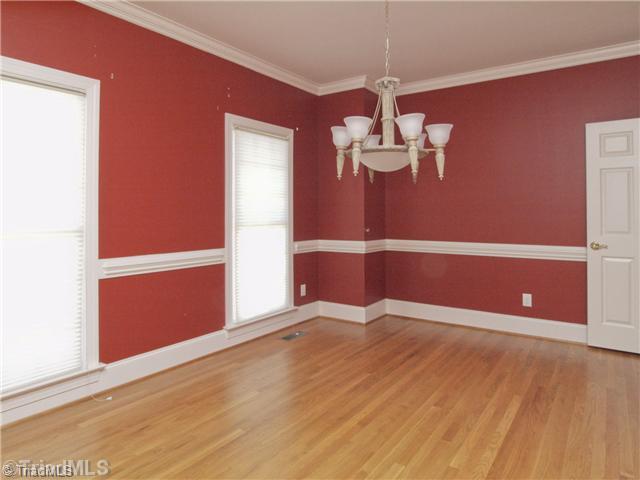 5411 Effieham Street Oak Ridge, NC 27310 - Photo 8 of 16 Dining Room. Dining room has extensive moldings, offset for china cabinet and wood flooring. Dining areas faces the front of the home.