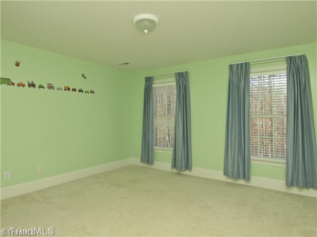 5411 Effieham Street Oak Ridge, NC 27310 - Photo 10 of 16 2nd Bedroom. Bedroom two is oversized because builder added two feet to the rear of the home when house was being built. Spectacular space and huge closets.