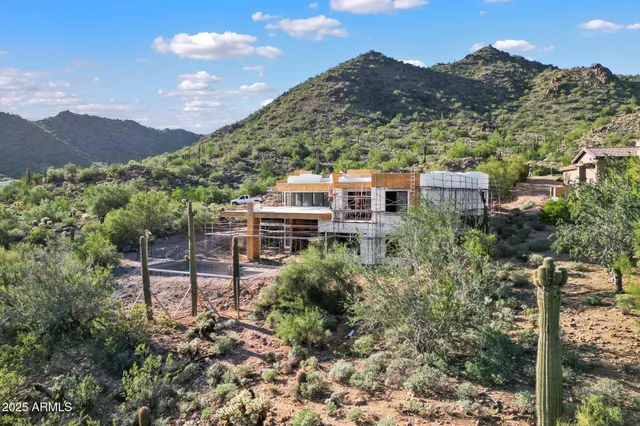 an aerial view of residential houses with yard
