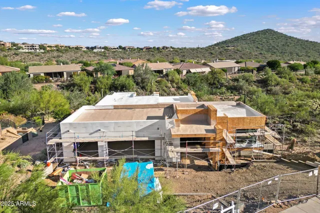 an aerial view of a house with a mountain view