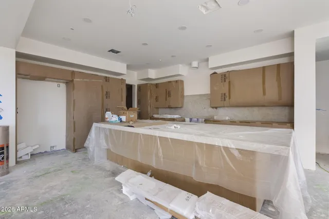 a view of a room that has a bed and a mirror