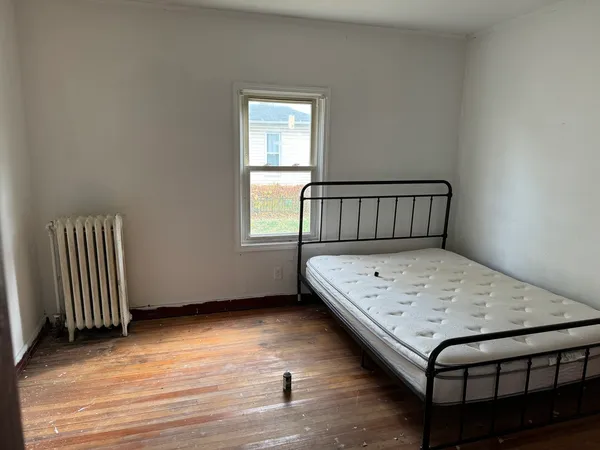 a view of a room with wooden floor and a window
