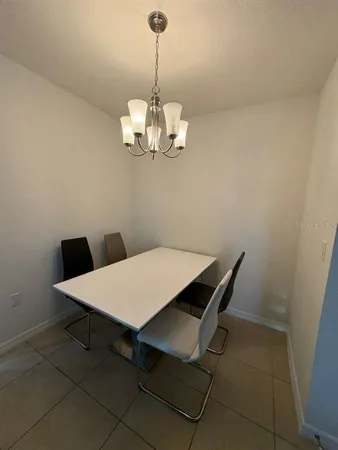 a dining room with a table and chairs