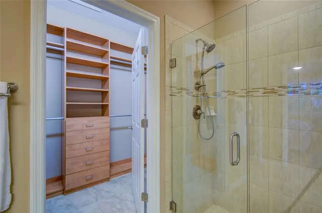 a bathroom with a shower and a glass door