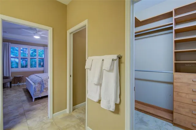 a view of walk in closet with empty racks