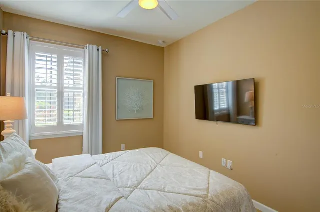 a bedroom with a bed and a lamp on dresser