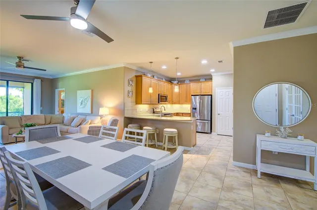 a large kitchen with a table and chairs