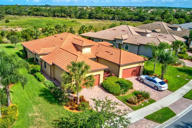 a front view of house with a garden