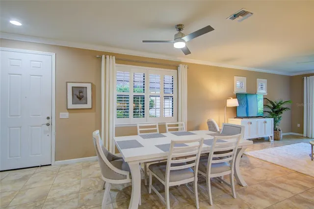 a view of a dining room with furniture and a chandelier