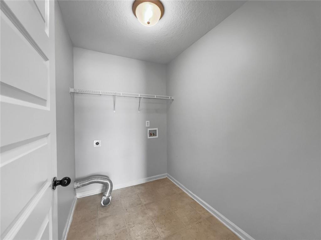 6 Pebblebrook Lane Fort Mitchell, AL 36856 - Photo 24 of 48 Washroom with hookup for an electric dryer, washer hookup, and a textured ceiling