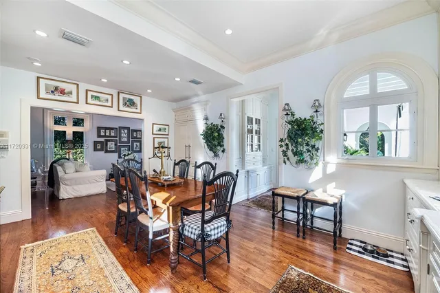 a living room with furniture floor to ceiling window and wooden floor