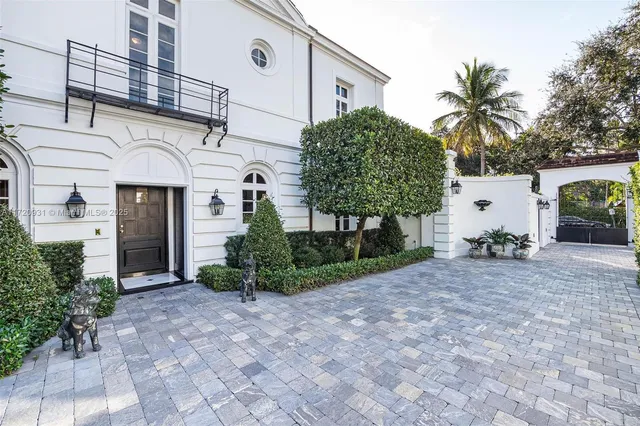 a dining room with furniture a chandelier and wooden floor