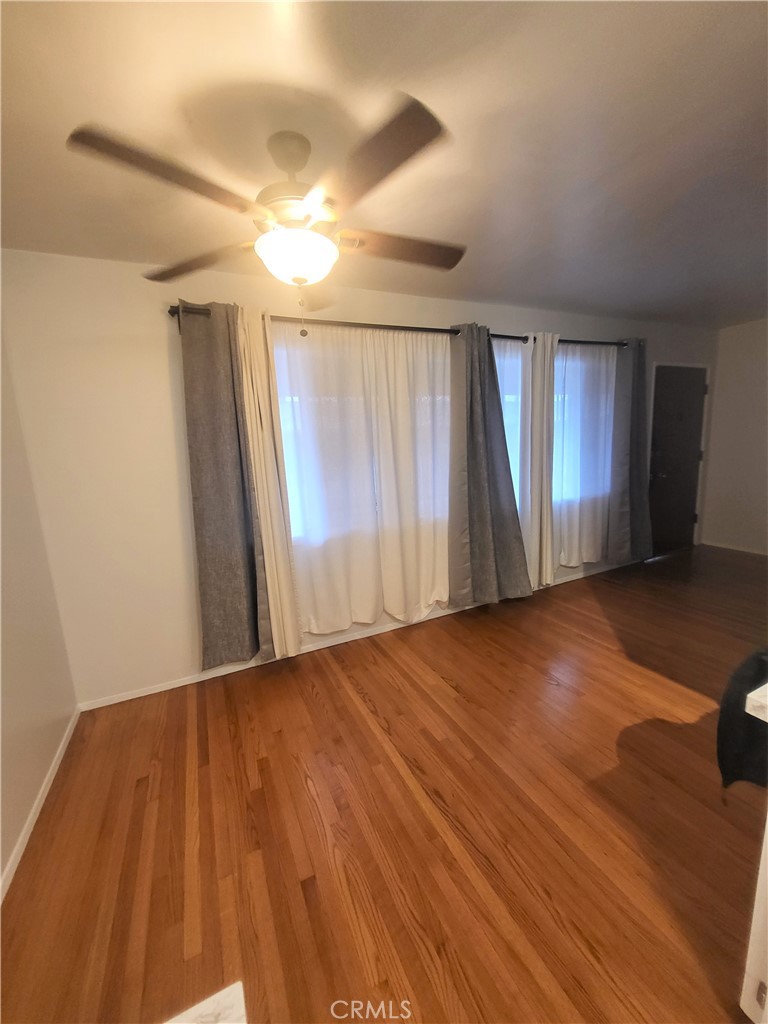 1057 East Appleton Street, Unit 7 Long Beach, CA 90802 - Photo 2 of 11 wooden floor in an empty room with a window