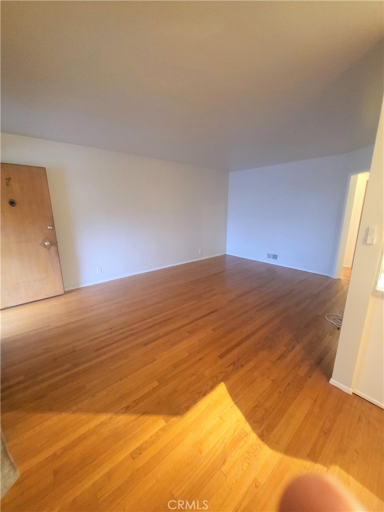 1057 East Appleton Street, Unit 7 Long Beach, CA 90802 - Photo 4 of 11 a view of empty room with wooden floor
