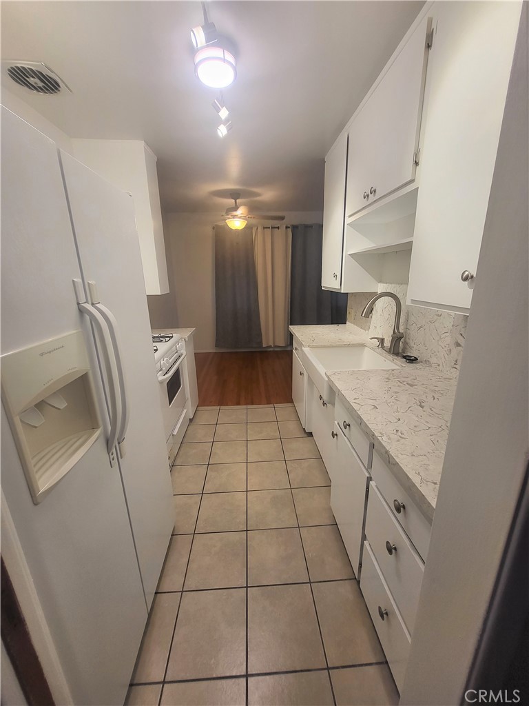 1057 East Appleton Street, Unit 7 Long Beach, CA 90802 - Photo 5 of 11 a spacious bathroom with a granite countertop sink a toilet and a mirror