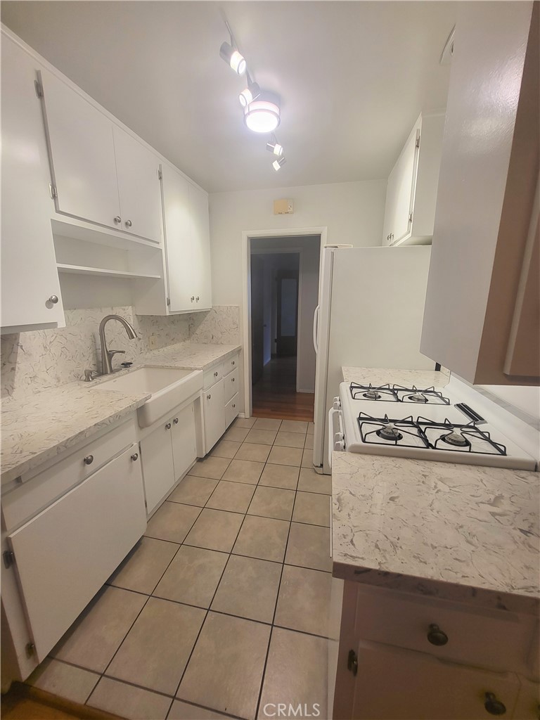 1057 East Appleton Street, Unit 7 Long Beach, CA 90802 - Photo 7 of 11 a kitchen with a stove sink and cabinets