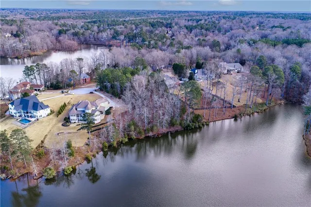 an aerial view of a house with garden space and lake view