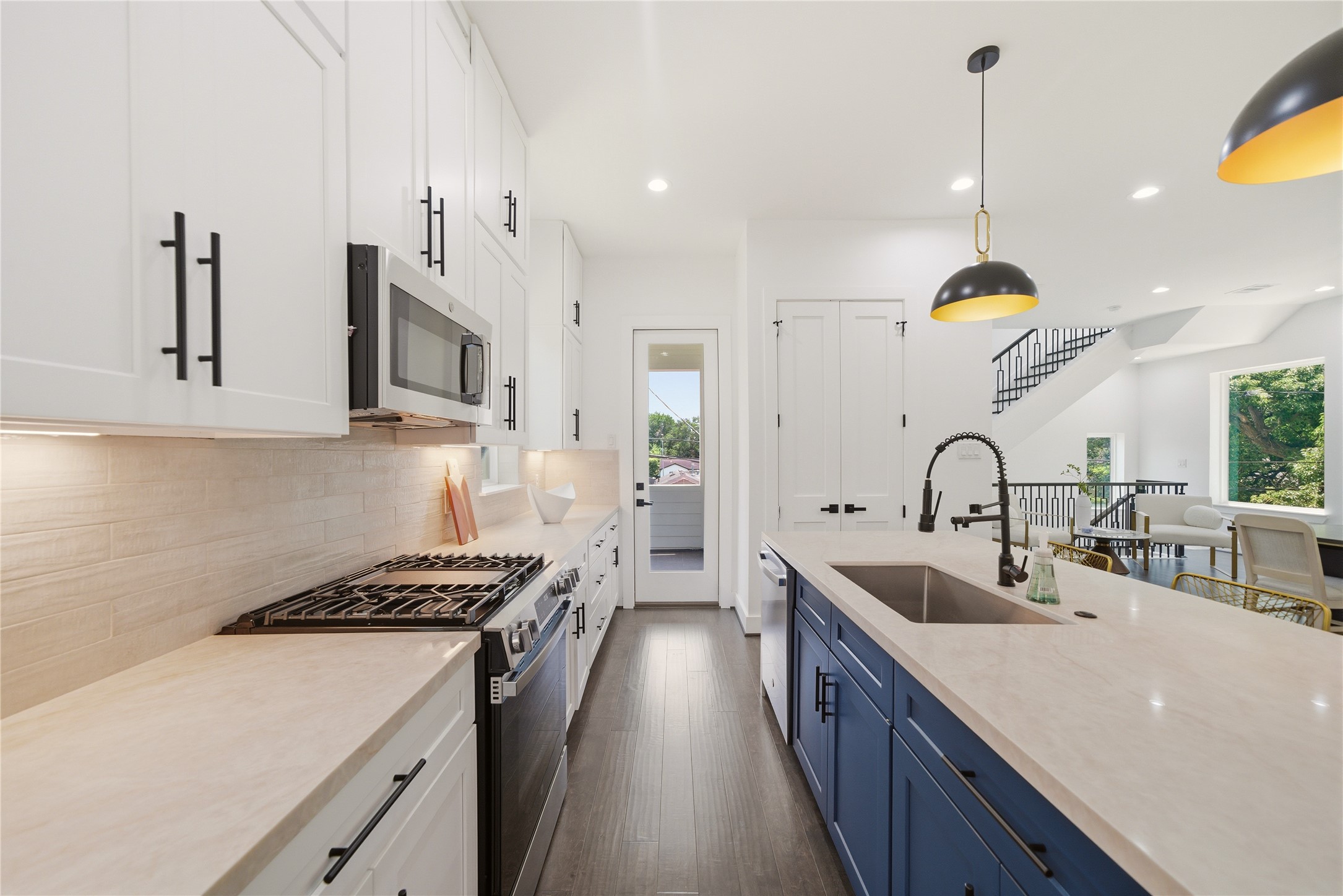 5024 Winnetka Street, Unit A Houston, TX 77021 - Photo 4 of 19 Taj Mahal Quartz countertops on beautiful waterfall design. With contrasting blue island cabinets and stainless steel appliances. Soft closing cabinets all around, with plenty of storage.