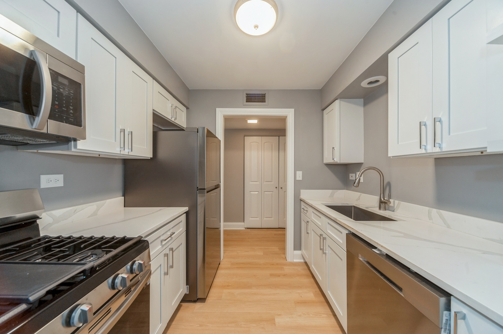 1455 Shermer Road, Unit 503C Northbrook, IL 60062 - Photo 2 of 11 a kitchen with stainless steel appliances granite countertop a stove and a sink