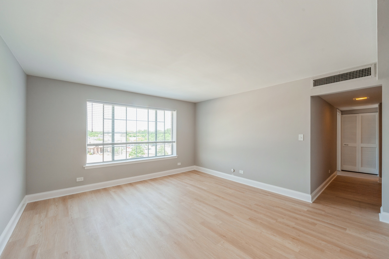 1455 Shermer Road, Unit 503C Northbrook, IL 60062 - Photo 5 of 11 an empty room with wooden floor and windows