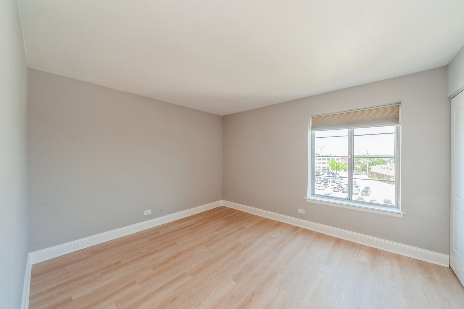1455 Shermer Road, Unit 503C Northbrook, IL 60062 - Photo 6 of 11 an empty room with wooden floor and windows