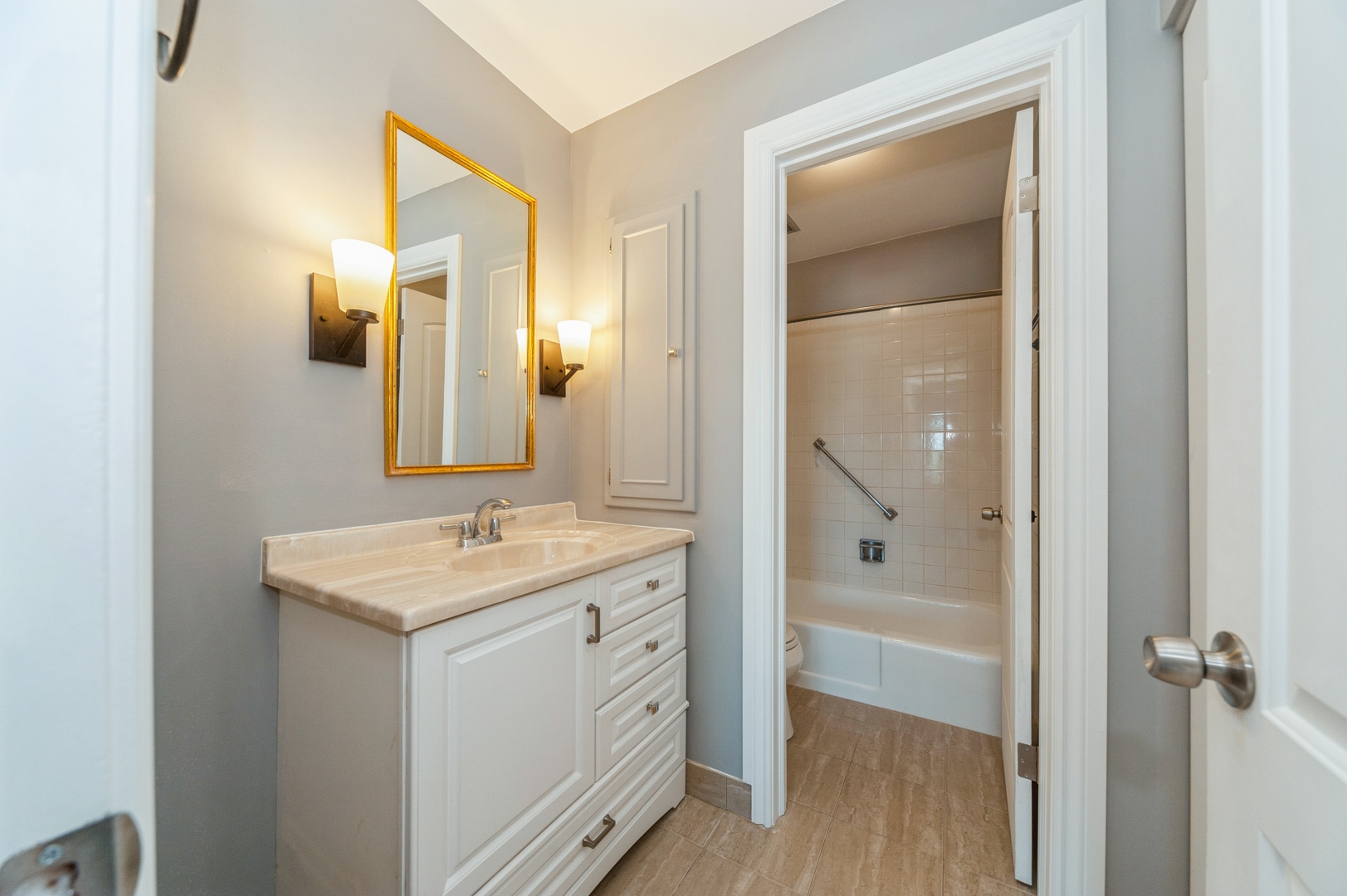 1455 Shermer Road, Unit 503C Northbrook, IL 60062 - Photo 7 of 11 a bathroom with a granite countertop sink mirror and a shower