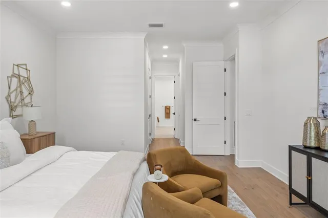 a spacious bedroom with a large bed and a flat screen tv