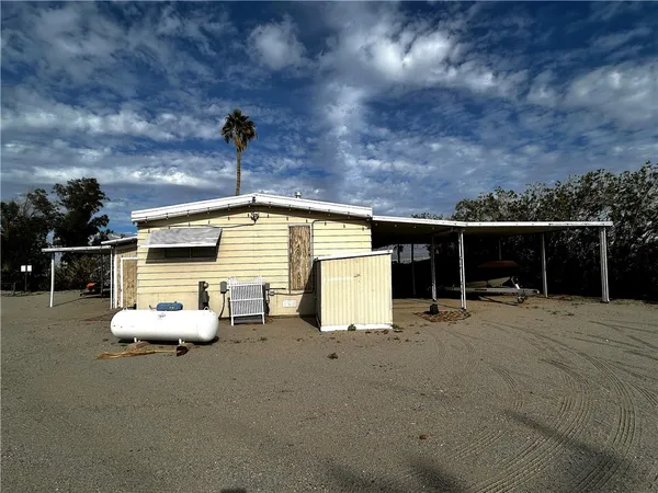 a backyard of a house with table and chairs